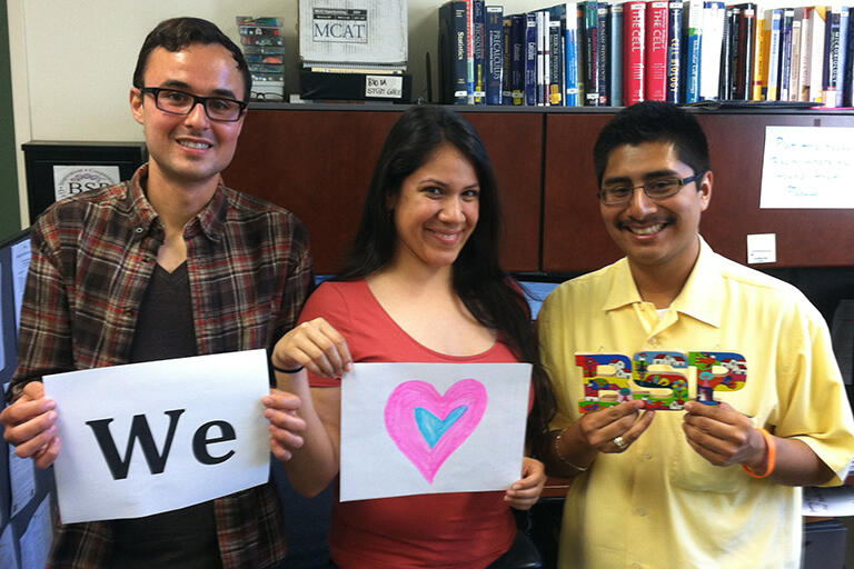 2 BSP staff and 1 member holding up a sign that says, "We heart BSP!"