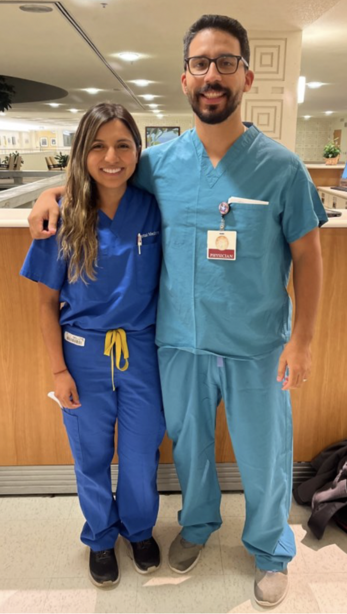 Juan Magana and Rubi Galarz wearing hospital scrubs, smiling
