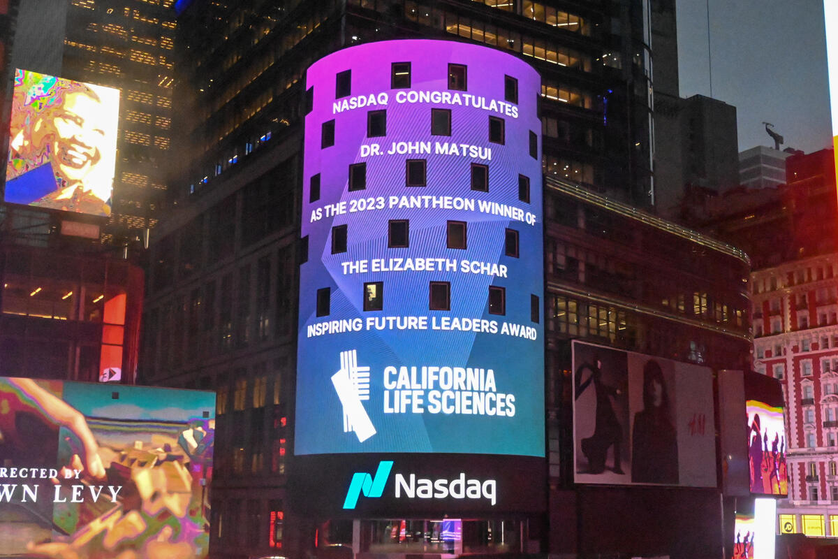a large electronic billboard with text that reads "Nasdaq congratulates Dr. John Matsui as the 2023 Pantheon winner of the Elizabeth Schar Inspiring Future Leaders Award"